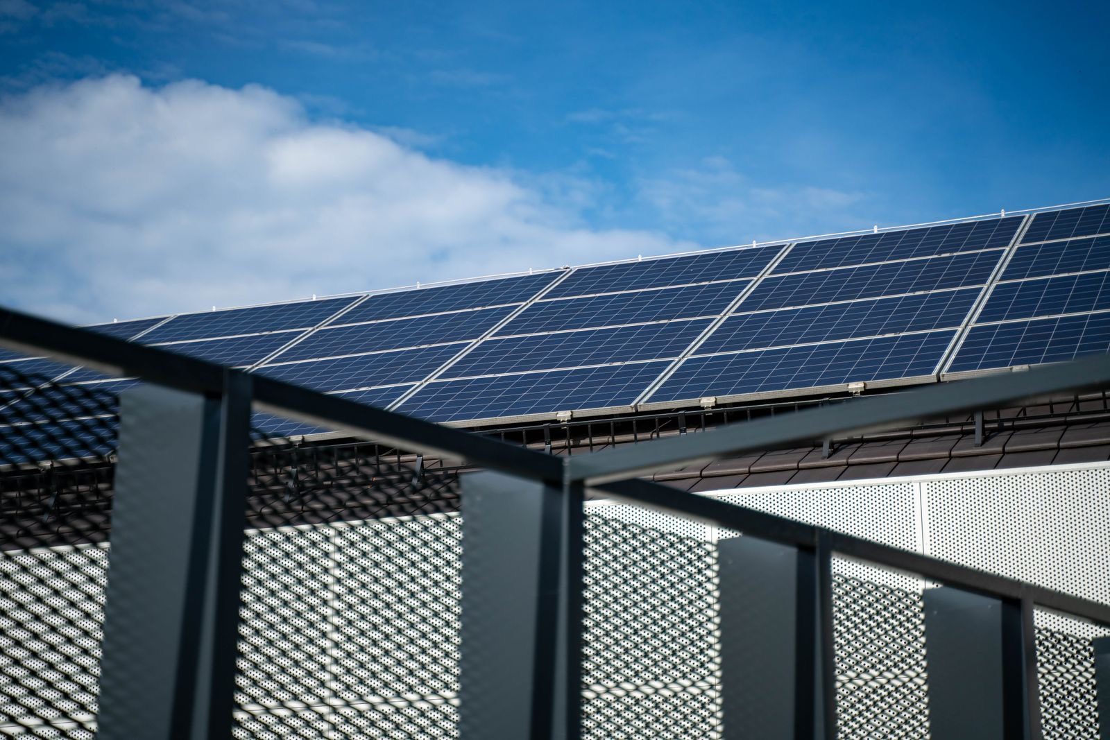 Commercial rooftop solar panels against a bright blue sky